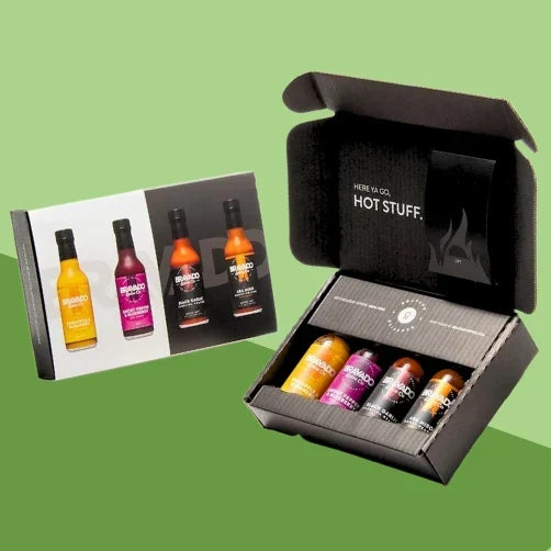 A Bravado Spice gift box containing four hot sauce bottles with distinct heat profiles.