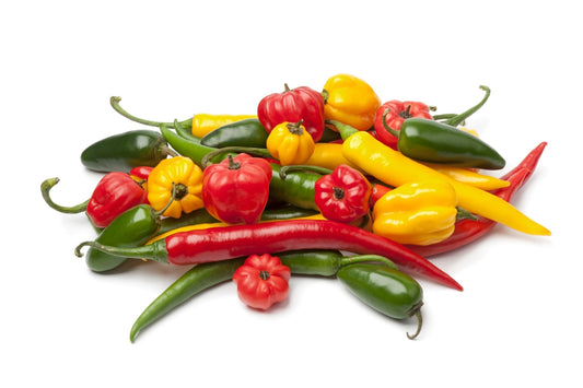 A collection of habanero, jalapeño, serrano, and ghost peppers, showcasing their diverse shapes and colors.